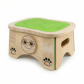 Doe the Turtle, a solid wood step stool with a green shell top, a smiling turtle face in glasses, and paw prints on the side.